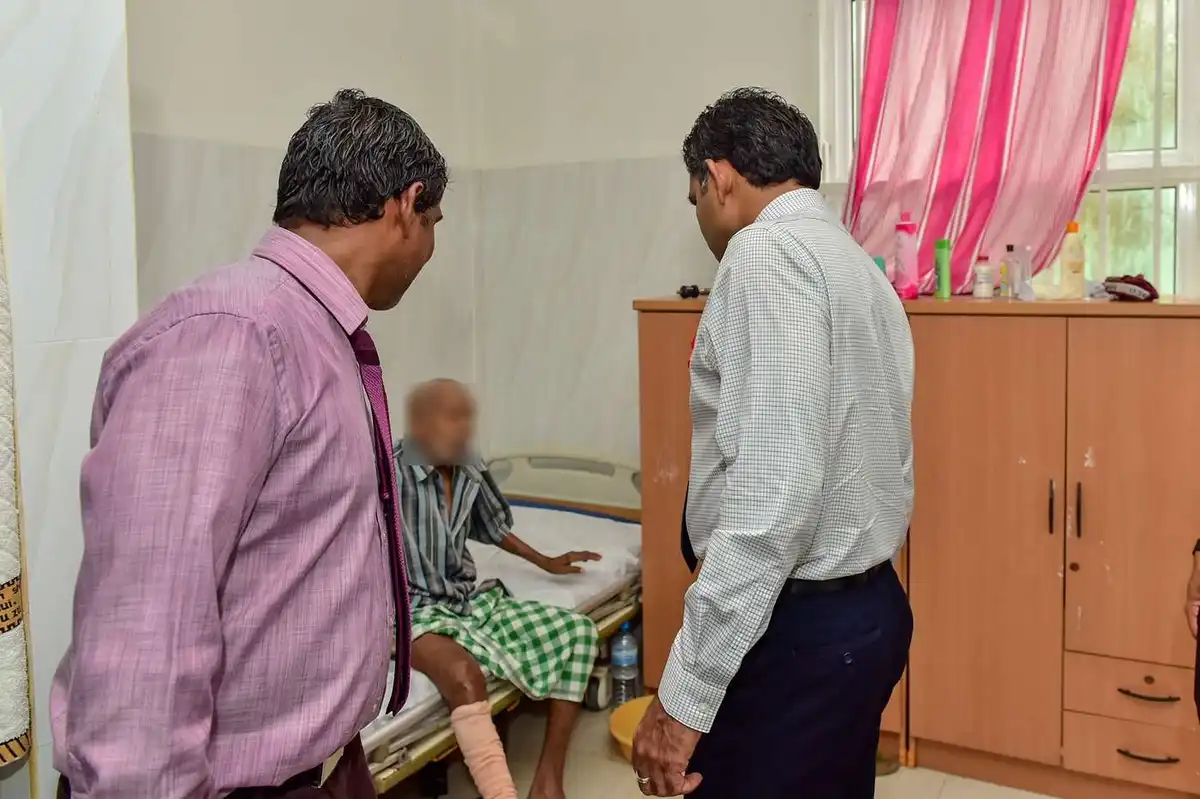 Former Vice President Faisal Naseem checks on a resident during a visit to the Home for People with Special Needs in K. Guraidhoo.