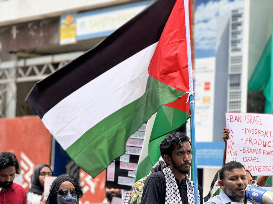 އިޒްރޭލް ޕާސްޕޯޓް މަނާކުރުމަށް ގޮވާލާ ކުރި މުޒާހަރާގެ ތެރެއިން - އެއްވުމަށް ދިޔަ ފަރާތްތަކުން ވަނީ އިސްރާއިލަށް އެެހީތެރިވެދޭ ފަރާތްތަކާއި، އުފެއްދުންތައްވެސް ރާއްޖެއަށް އެތެރެވުން މަނާކުރުމަށް ގޮވާލާ ލިޔެފައި ބޯޑްތައް ހިފައިގެން އަޑު އުފުލާފަ - ފޮޓޯ: ޙުސައިން މަޚްތޫމް