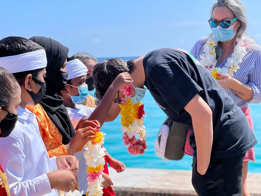 The first tourists being welcomed to Th. Buruni island's first guesthouse