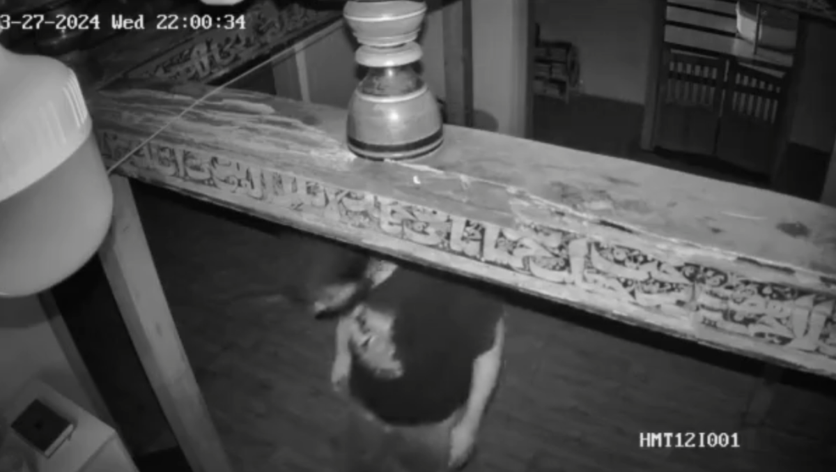 The suspect is seen stealing a fan from Taqwa Mosque