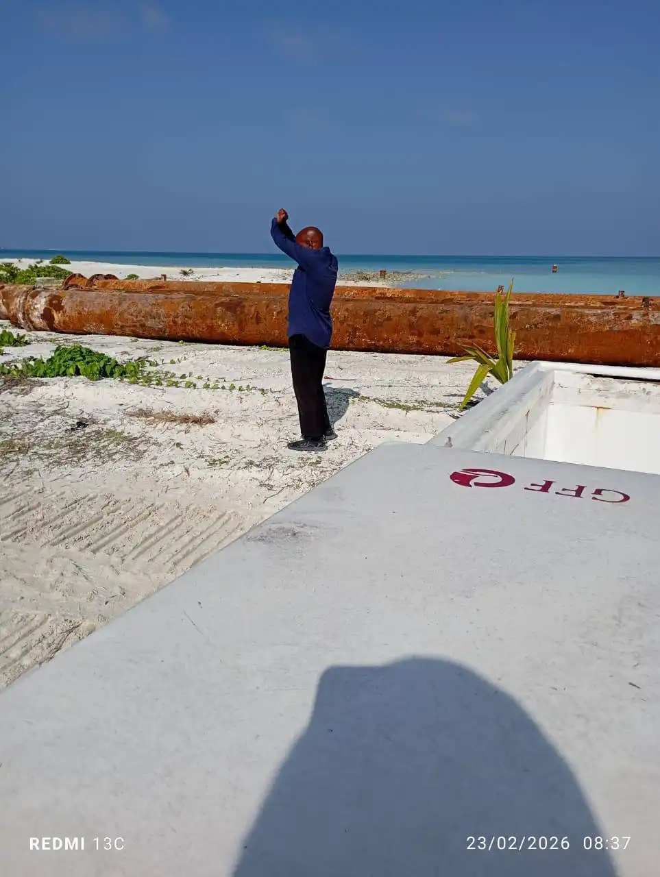A protester demonstrates against an MTCC barge arriving to collect construction materials, including sand and gravel, previously brought for the development of the F. Magoodhoo Airport.