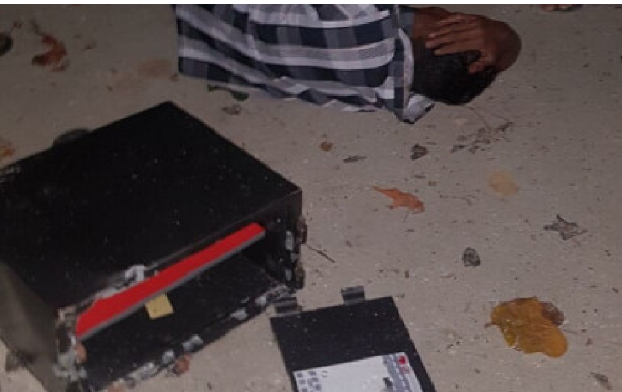 An injured man is seen laying down next to a stolen safe in Dhiffushi